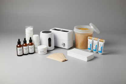 1x Single Wax Warmer, 1x Dual Roller Wax Warmer, 1x 1kg Hot Wax, 4x 100ml Warm Wax Cartridge, 100x Regular Wooden Spatulas, 100x Paper Wax Strips, 1x Pre-Wax Lotion, 1x Post-Wax Oil, 1x Soothing Gel & 1x Talcum Powder, 1x Equipment Cleaner, 100x Cotton Pads with grey studio background